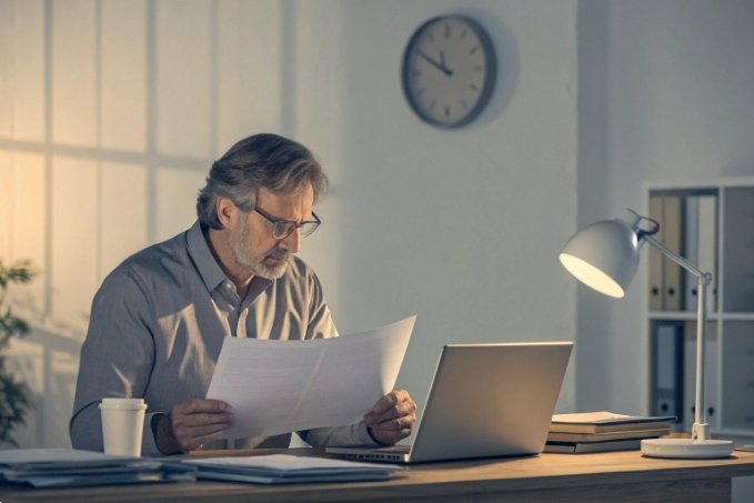 Professional reviewing documents at night