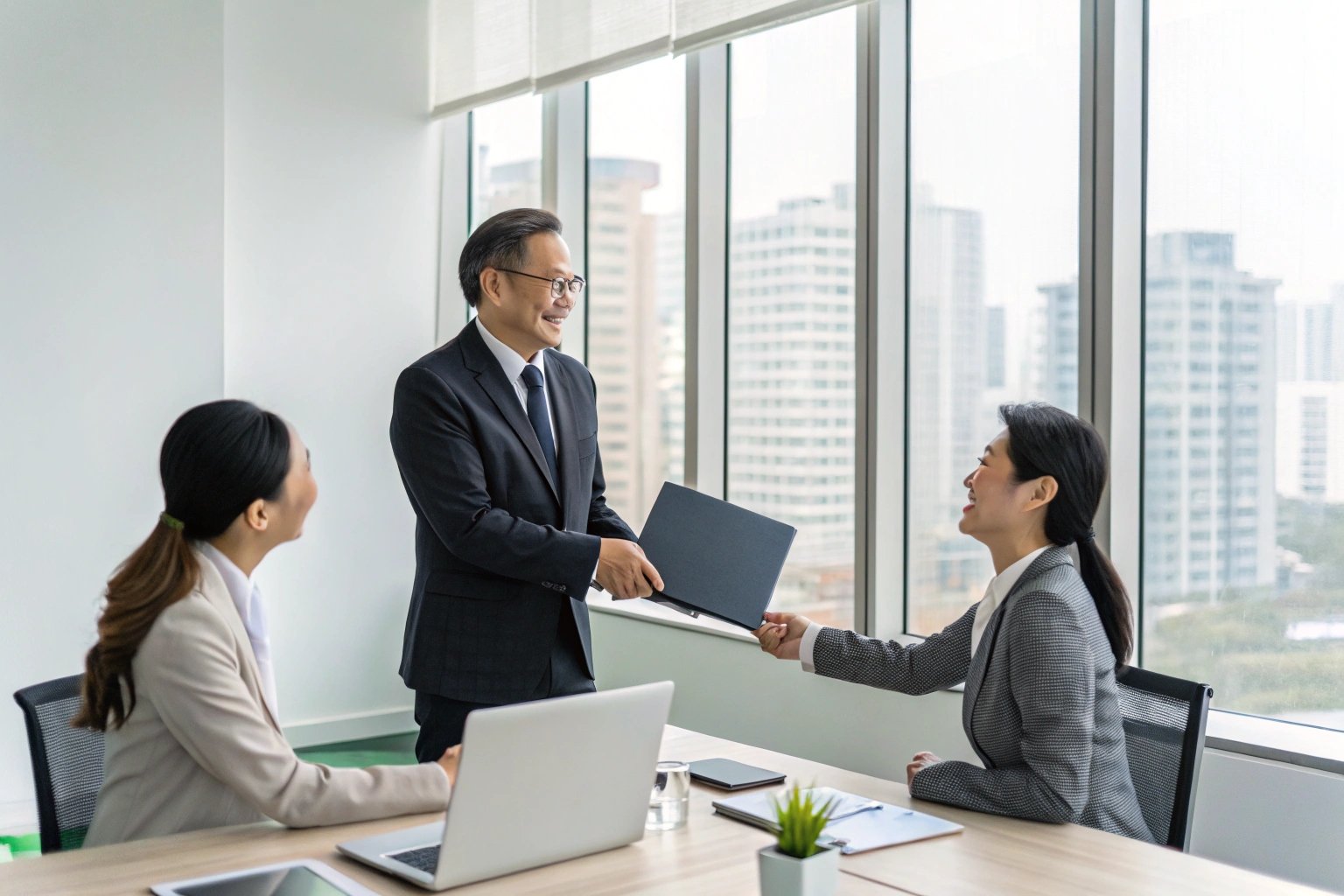 Business team in a modern office exchanging documents during a corporate meeting.